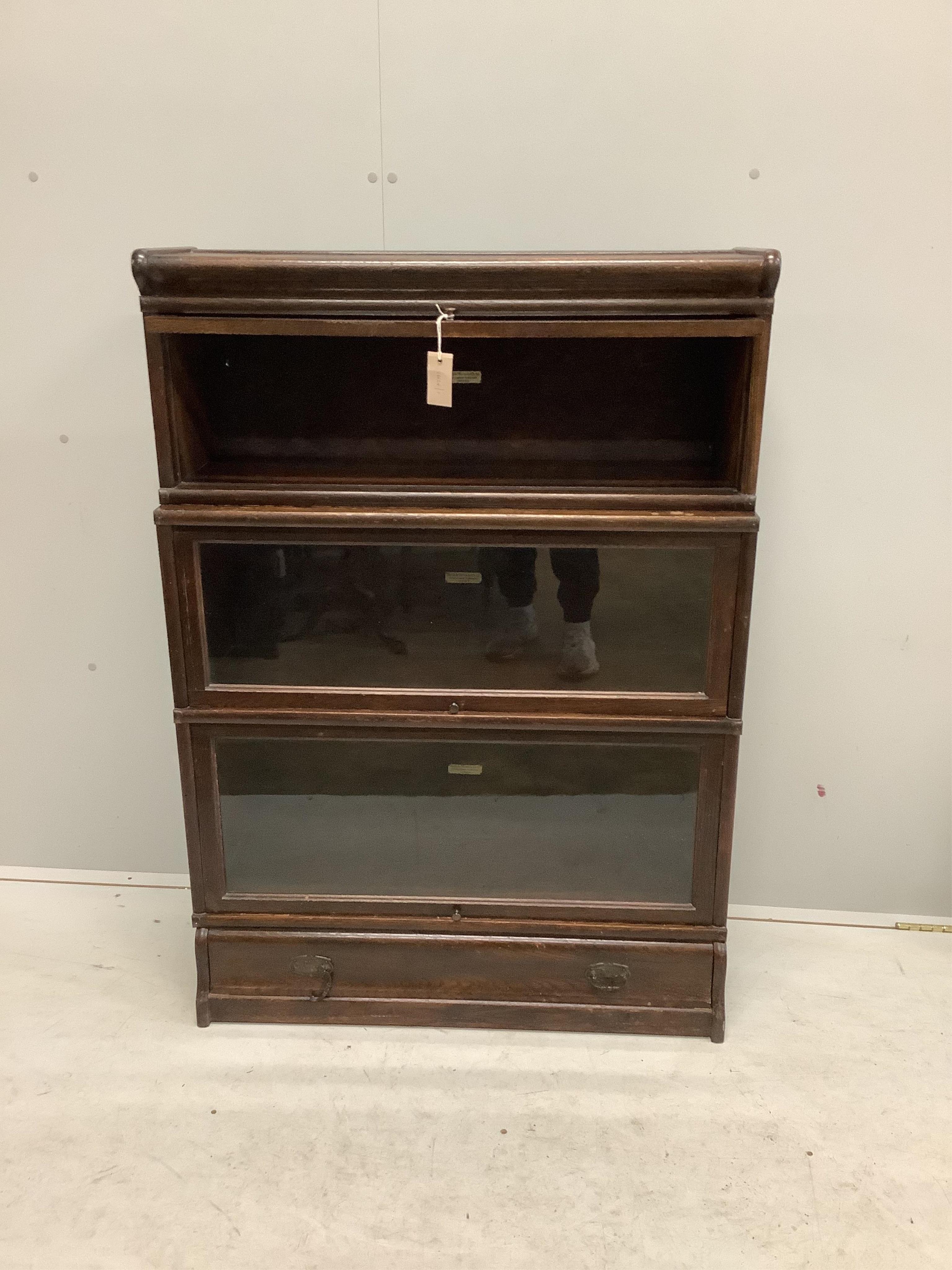 A Globe Wernicke oak three section bookcase, width 86cm, depth 33cm, height 122cm. Condition - fair